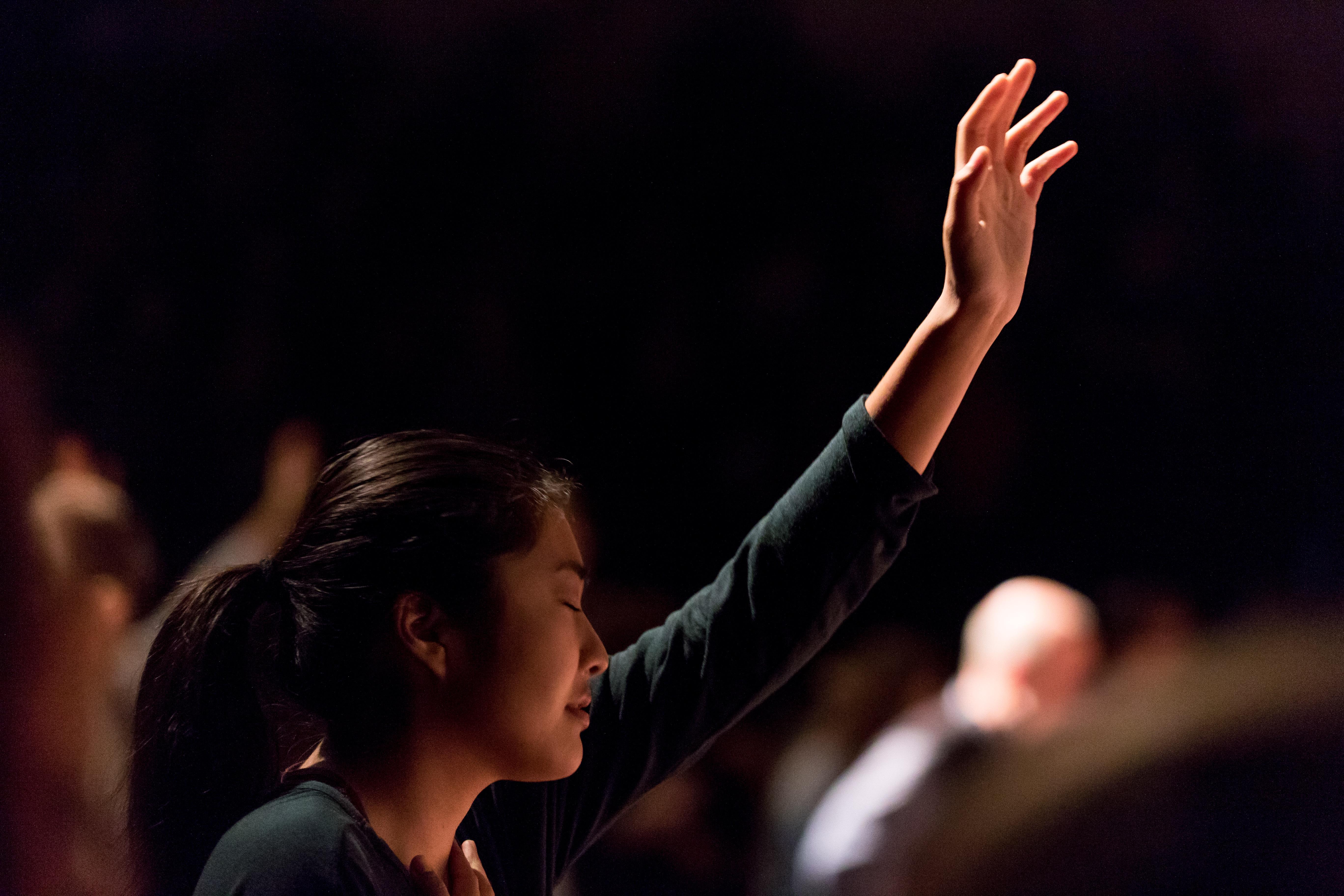 woman worshiping at chapel