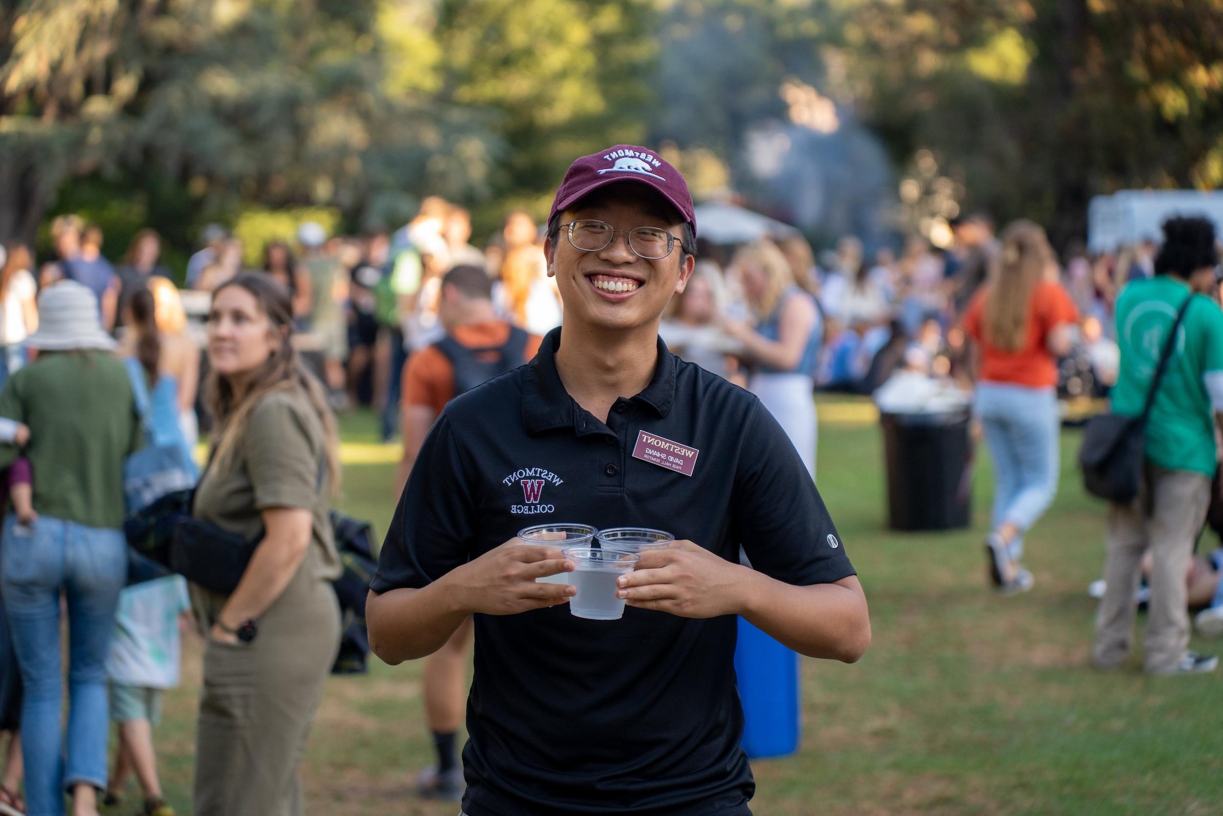 student carrying water at event